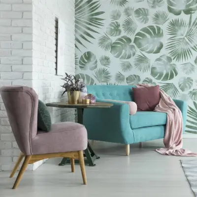 Appartement lumineux avec mur de briques blanches et papier peint à feuilles de monstera dans un salon à thème botanique.